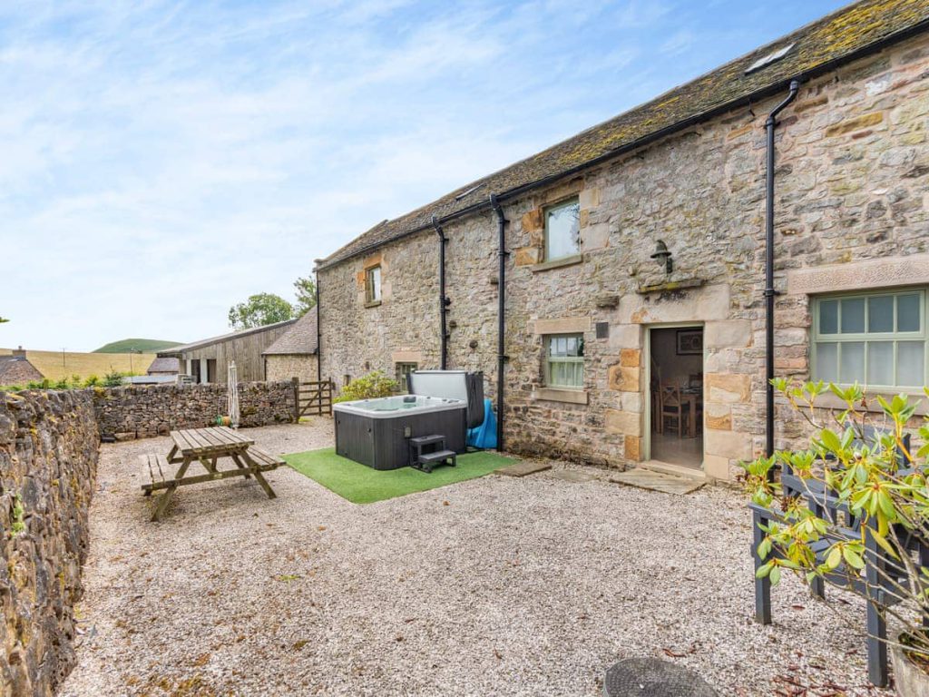 Stone cottage courtyard with a private hot tub