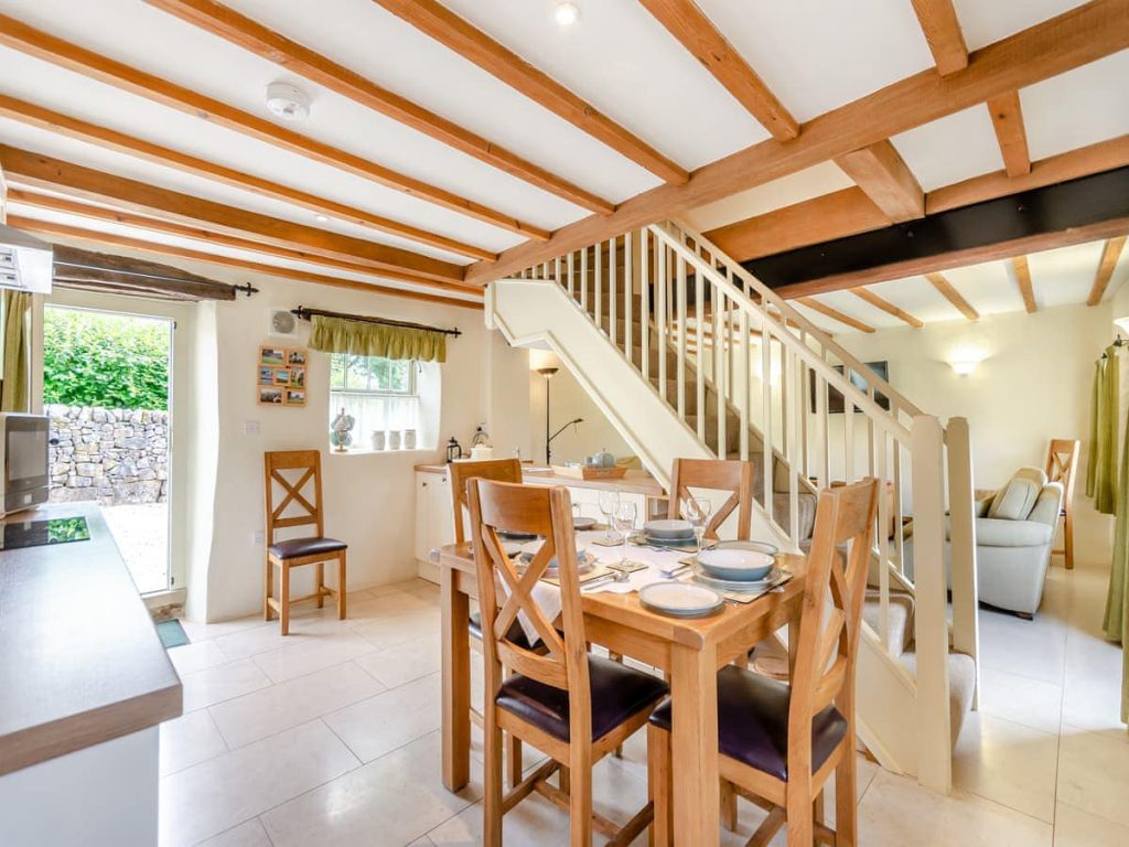 Cottage dining area beside the staircase and kitchen